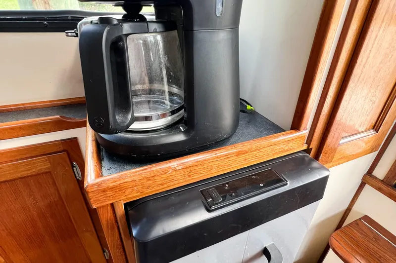 Mirage Yacht Photos Pics Coffee maker on wooden counter in Nordic 32, 1999 model interior.