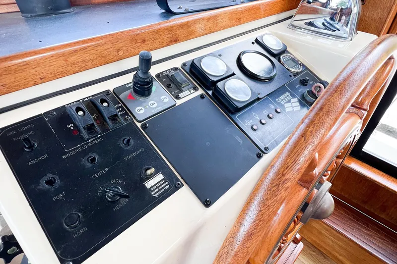 Mirage Yacht Photos Pics 1999 Nordic 32 boat dashboard with wooden steering wheel and control panel.