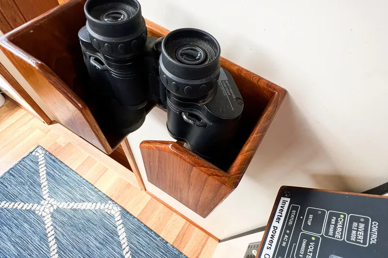 Mirage Yacht Photos Pics Binoculars in wooden holder on Nordic 32 boat, 1999 model, with inverter control panel nearby.