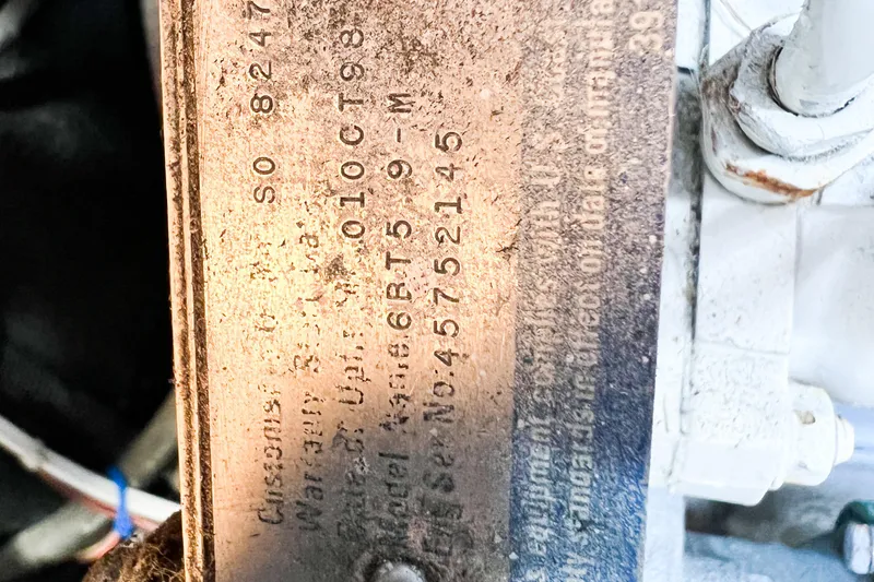 Mirage Yacht Photos Pics Close-up of a metal plate with engraved serial numbers on a Nordic 32, 1999 model.