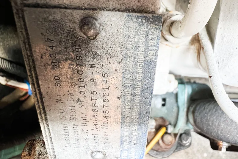 Mirage Yacht Photos Pics Close-up of a metal identification plate on a 1999 Nordic 32 engine.