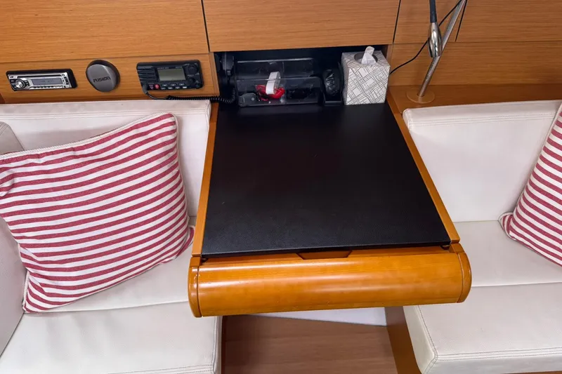 Kairos Yacht Photos Pics Interior of 2013 Jeanneau 409 yacht with navigation station and striped cushions.