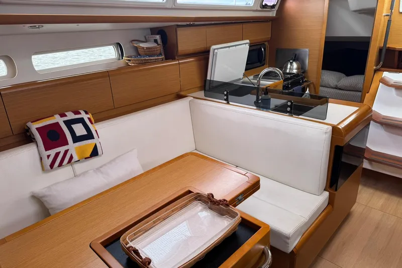 Kairos Yacht Photos Pics Interior of 2013 Jeanneau 409 sailboat with cozy seating and modern kitchen area.