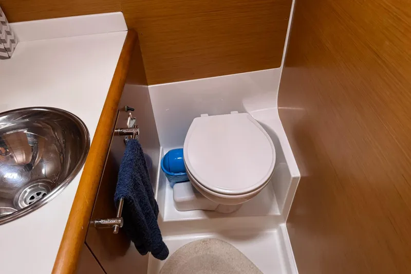 Kairos Yacht Photos Pics Bathroom interior of 2013 Jeanneau 409 yacht with sink and toilet.