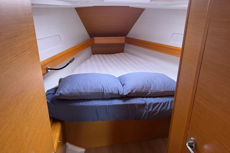 Kairos Yacht Photos Pics Cozy cabin interior of 2013 Jeanneau 409 sailboat with comfortable bedding.