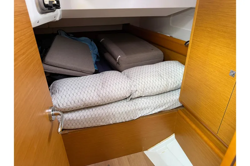 Kairos Yacht Photos Pics Cozy cabin interior of 2013 Jeanneau 409 sailboat with cushions and bedding.