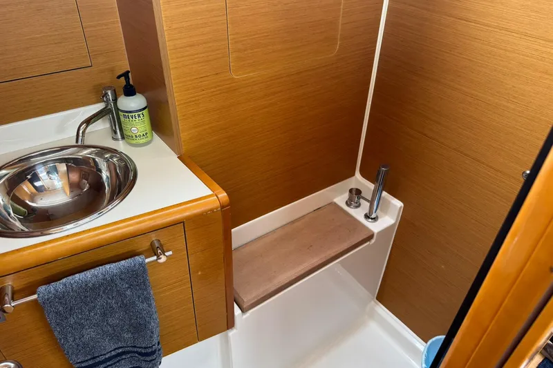 Kairos Yacht Photos Pics Bathroom interior of 2013 Jeanneau 409 yacht with sink and shower area.