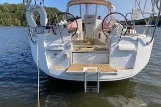 Kairos Yacht Photos Pics 2013 Jeanneau Sun Odyssey 409 sailboat on calm water, rear view.