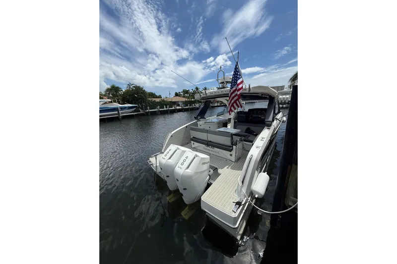  Yacht Photos Pics 2024 Galeon 325 GTO boat docked, featuring dual outboard engines and an American flag.