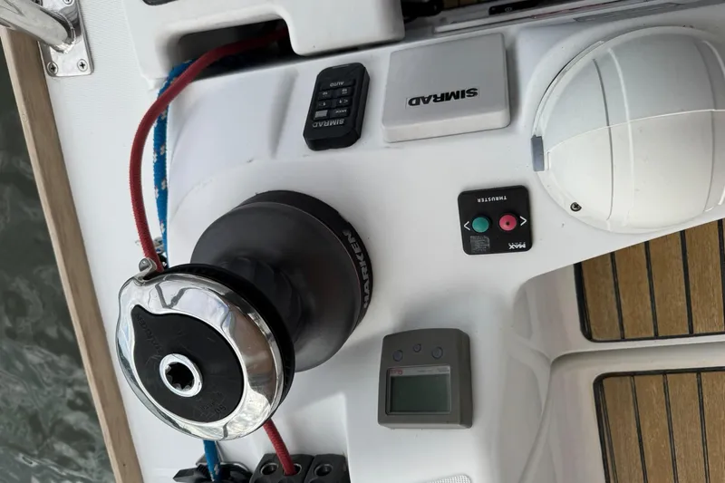 Kairos Yacht Photos Pics Jeanneau 409 sailboat deck with winch, control panel, and teak flooring.