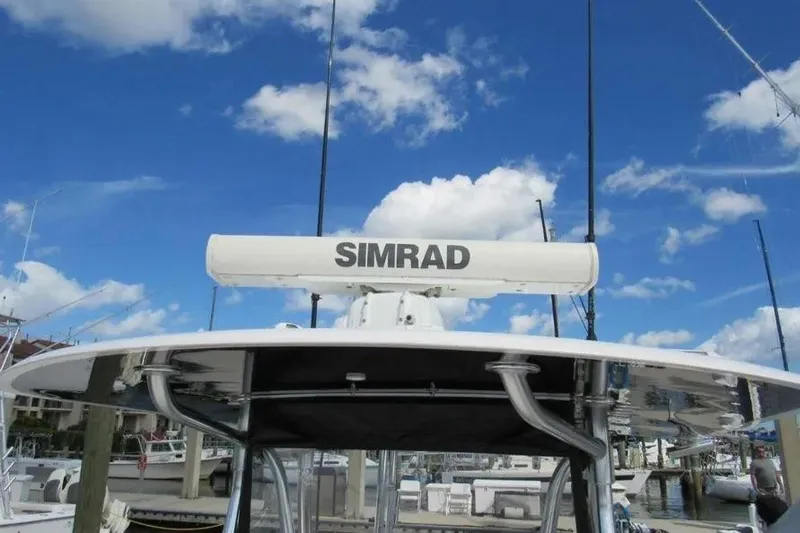  Yacht Photos Pics 2019 Contender 39 ST boat with Simrad radar, clear blue sky background.