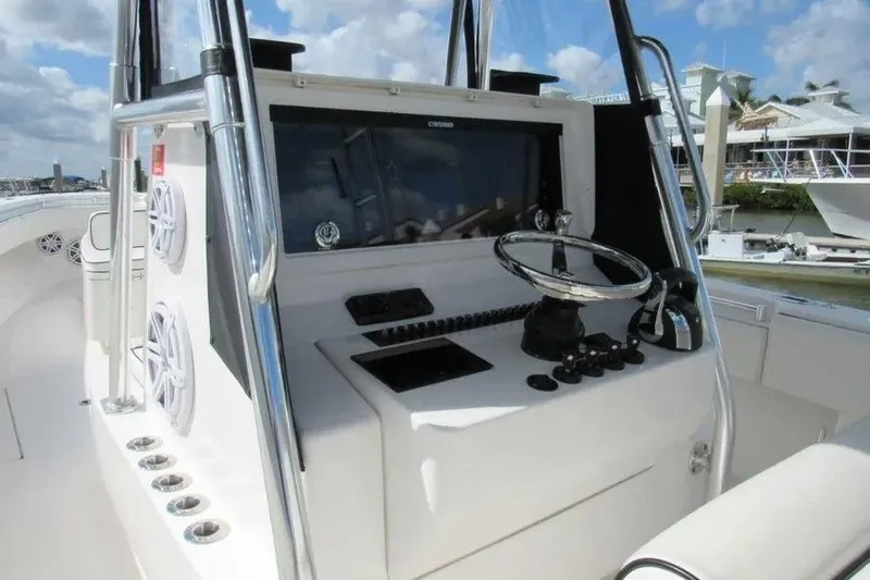  Yacht Photos Pics 2019 Contender 39 ST boat console with steering wheel and controls, docked at marina.