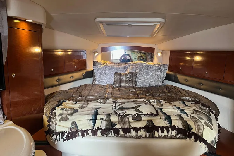 Chance Encounter Yacht Photos Pics Luxurious cabin interior of 2004 Sea Ray 340 Sundancer with cozy bedding and wood accents.