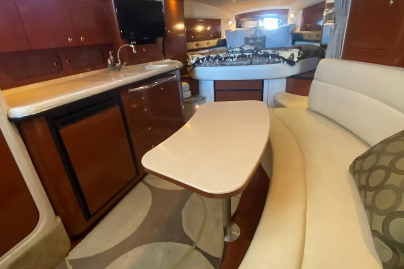 Chance Encounter Yacht Photos Pics Interior of 2004 Sea Ray 340 Sundancer with kitchenette, seating, and bed.
