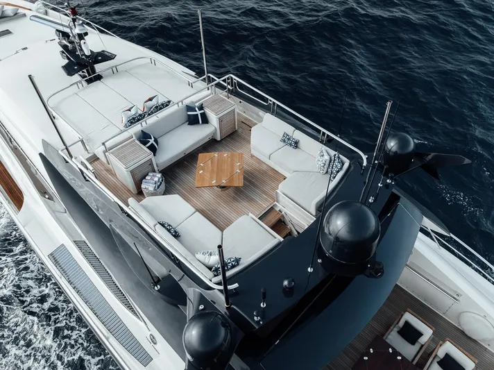 Burn Rate Yacht Photos Pics Luxurious 2006 Palmer Johnson Express yacht with elegant deck seating, cruising on open water.