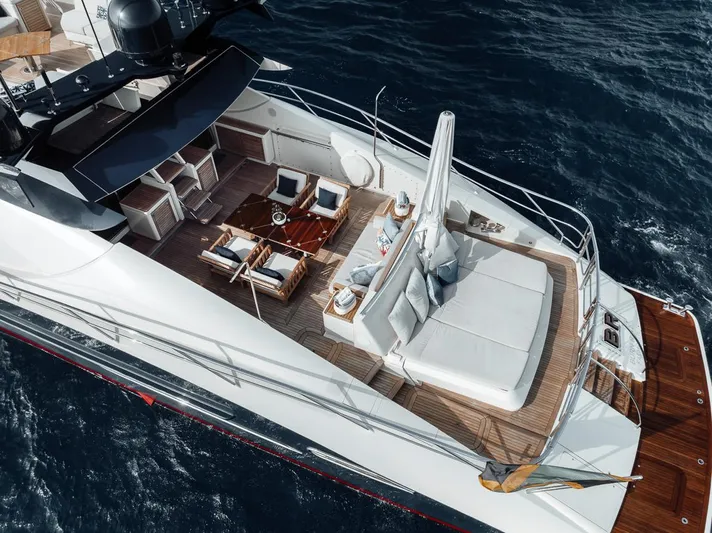 Burn Rate Yacht Photos Pics Luxurious 2006 Palmer Johnson Express yacht with elegant deck seating and ocean backdrop.