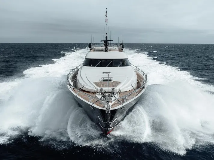 Burn Rate Yacht Photos Pics 2006 Palmer Johnson Express yacht cruising powerfully through ocean waves.