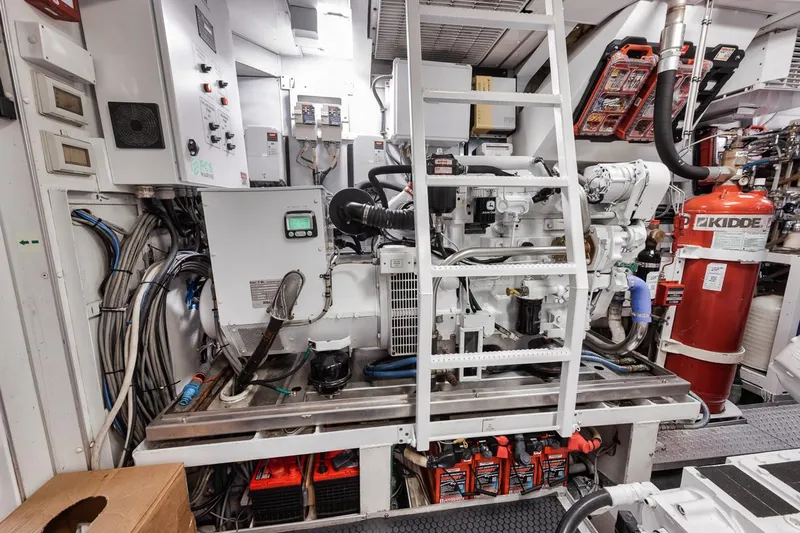 Burn Rate Yacht Photos Pics Engine room of a 2006 Palmer Johnson Express yacht, featuring machinery and safety equipment.