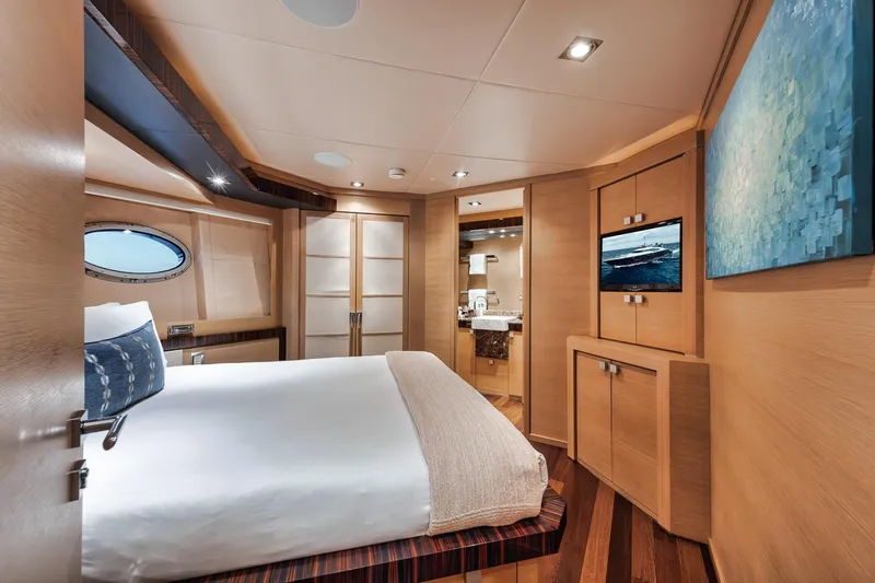 Burn Rate Yacht Photos Pics Luxurious 2006 Palmer Johnson Express yacht bedroom with modern decor and elegant wood finishes.