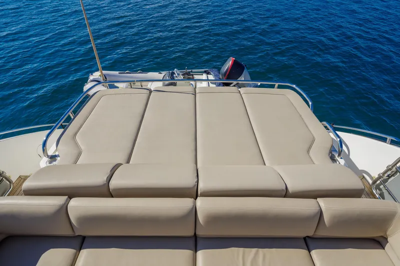 Black Sugar Yacht Photos Pics Luxurious sunbathing deck on 2010 Princess V78 yacht, overlooking serene blue ocean waters.