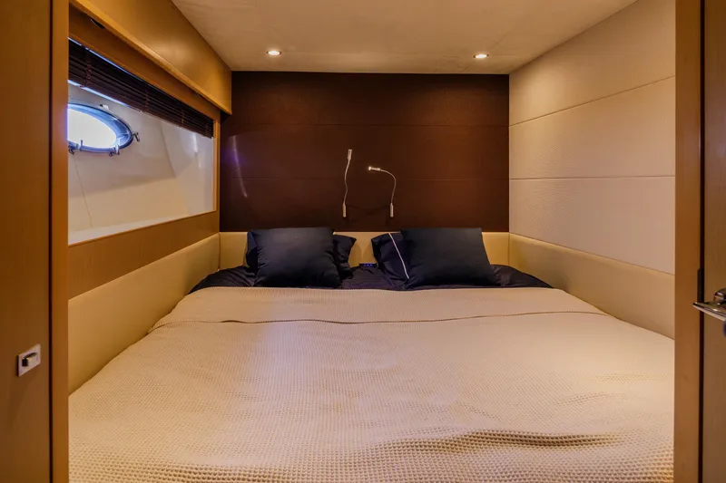 Black Sugar Yacht Photos Pics Luxurious cabin interior of 2010 Princess V78 yacht with cozy bedding and porthole window.