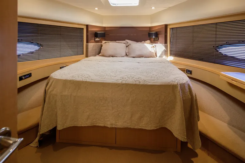 Black Sugar Yacht Photos Pics Luxurious bedroom interior of 2010 Princess V78 yacht with elegant bedding and ambient lighting.