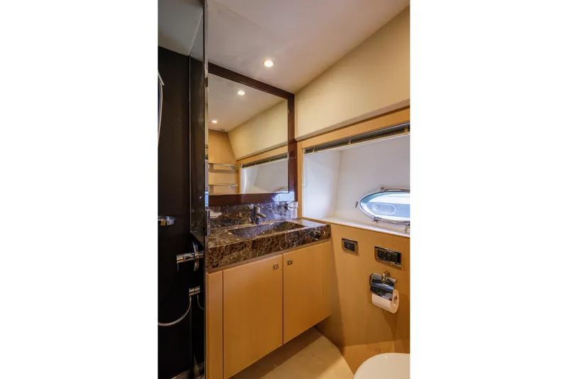 Black Sugar Yacht Photos Pics Luxurious bathroom in 2010 Princess V78 yacht with marble countertop and modern fixtures.