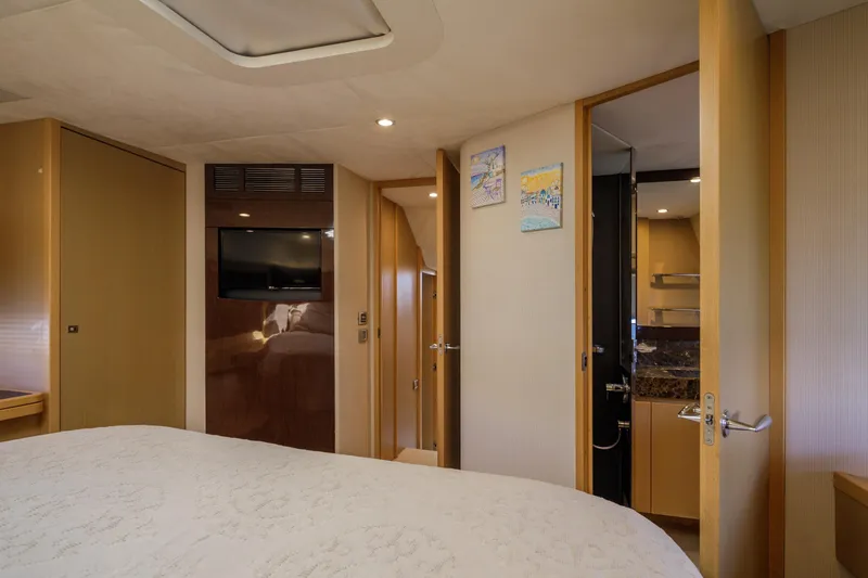 Black Sugar Yacht Photos Pics Luxurious interior of 2010 Princess V78 yacht cabin with TV and ensuite bathroom.