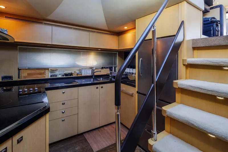 Black Sugar Yacht Photos Pics Luxurious kitchen interior of 2010 Princess V78 yacht with modern appliances and sleek design.