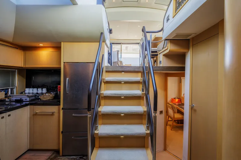 Black Sugar Yacht Photos Pics Interior of 2010 Princess V78 yacht with modern kitchen and staircase.