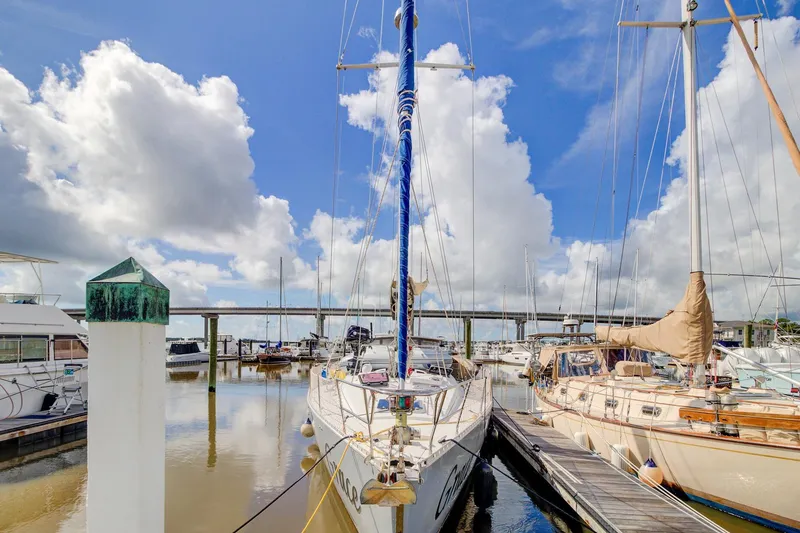Grace Yacht Photos Pics 1994 Beneteau 510 sailboat docked at marina under cloudy sky.