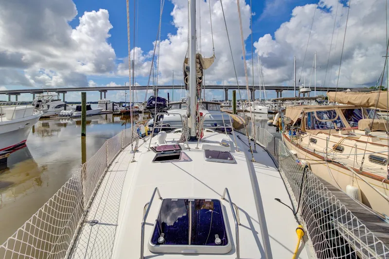 Grace Yacht Photos Pics Sailboat docked in marina, Beneteau 510, 1994 model, under a cloudy sky.