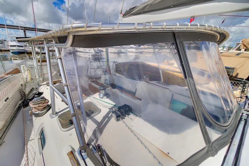 Grace Yacht Photos Pics 1994 Beneteau 510 sailboat cockpit with clear enclosure, docked at marina.