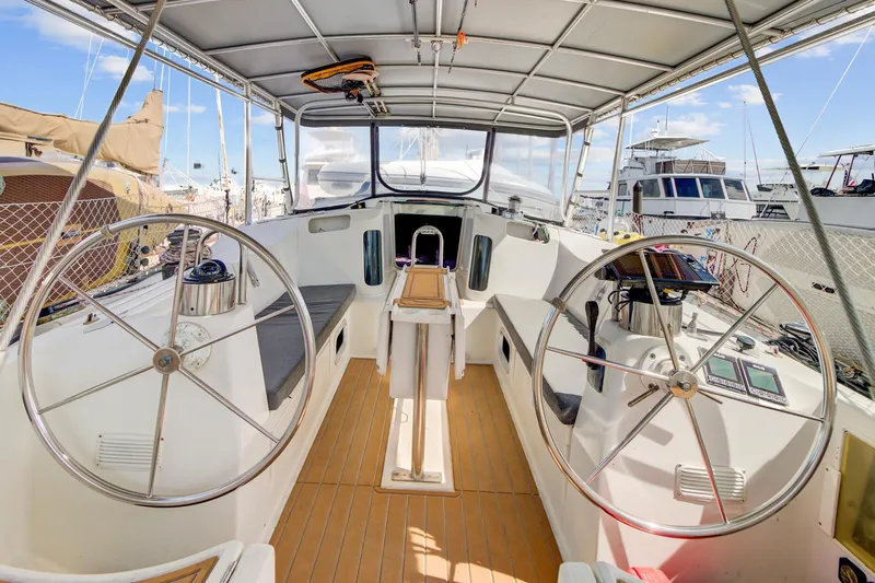 Grace Yacht Photos Pics Cockpit of 1994 Beneteau 510 sailboat with dual steering wheels and teak flooring.