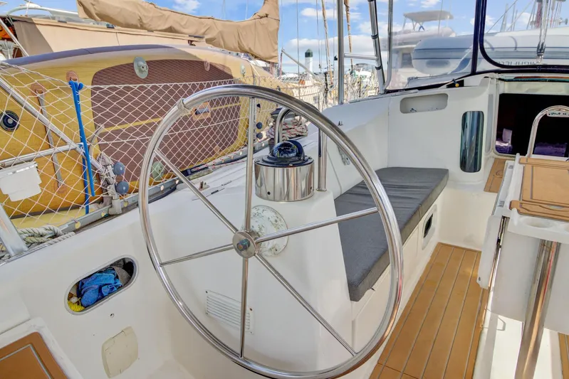 Grace Yacht Photos Pics Cockpit of 1994 Beneteau 510 sailboat with steering wheel and seating area.
