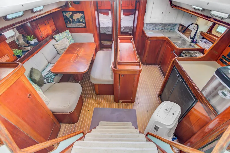 Grace Yacht Photos Pics Interior of a 1994 Beneteau 510 yacht with wood finishes and cozy seating area.