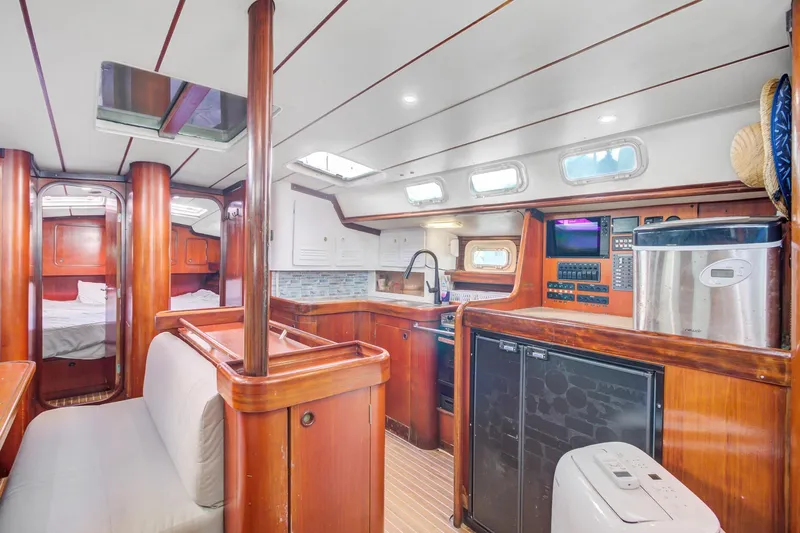 Grace Yacht Photos Pics Interior of a 1994 Beneteau 510 yacht with wood finishes and modern amenities.