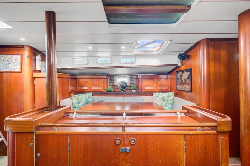 Grace Yacht Photos Pics Interior of 1994 Beneteau 510 sailboat with wooden furnishings and seating area.