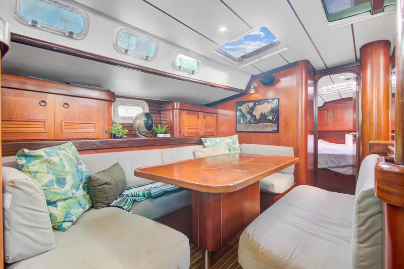 Grace Yacht Photos Pics Spacious interior of 1994 Beneteau 510 yacht with cozy seating and elegant wood finish.