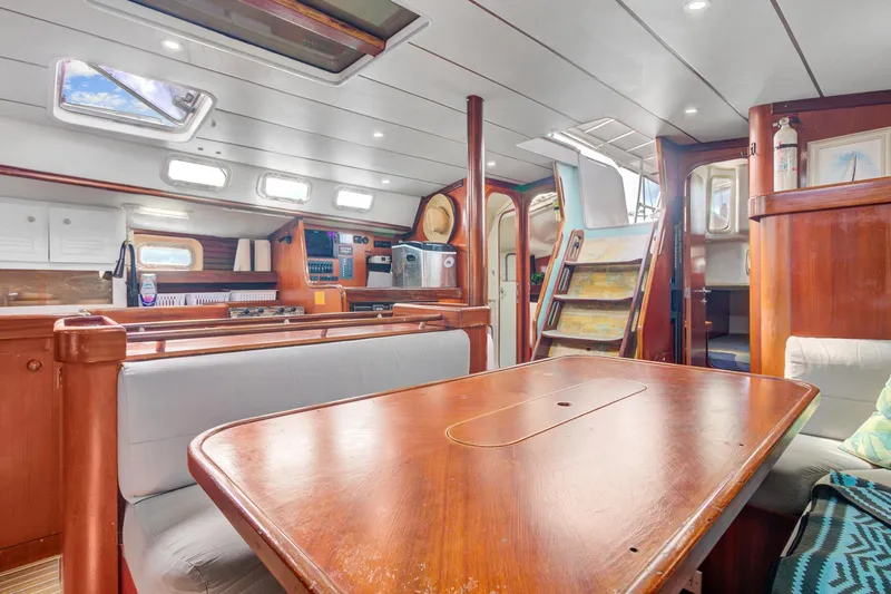 Grace Yacht Photos Pics Interior of 1994 Beneteau 510 yacht, featuring wooden dining table and modern amenities.