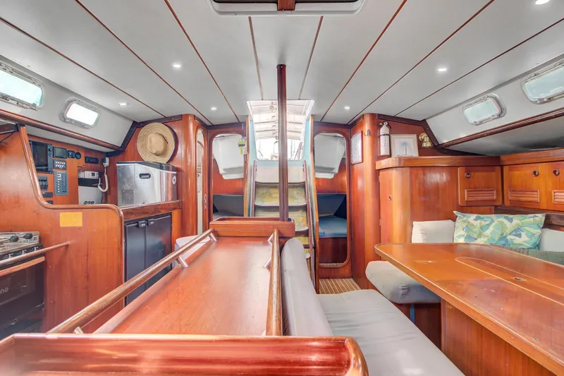 Grace Yacht Photos Pics Interior of 1994 Beneteau 510 sailboat with wooden furnishings and cozy seating area.
