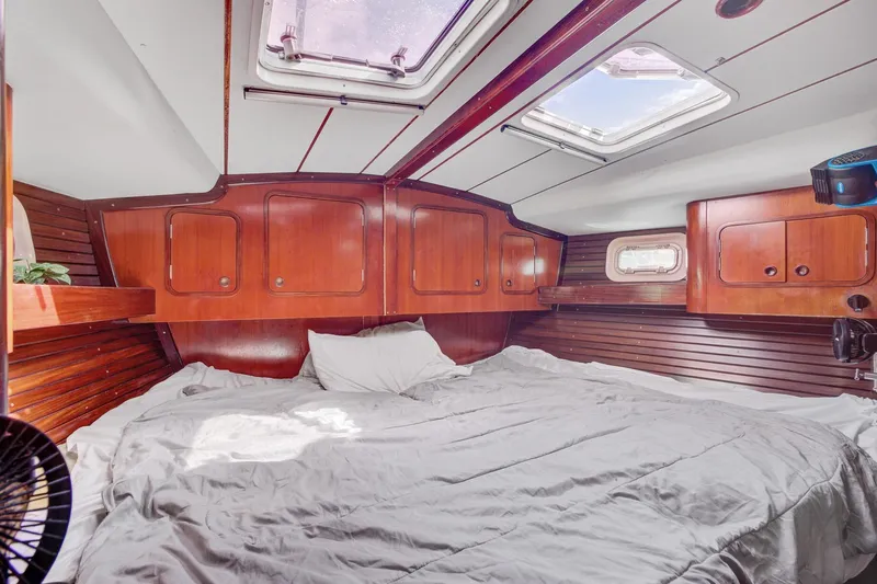 Grace Yacht Photos Pics Cozy cabin interior of 1994 Beneteau 510 sailboat with wooden paneling and skylights.