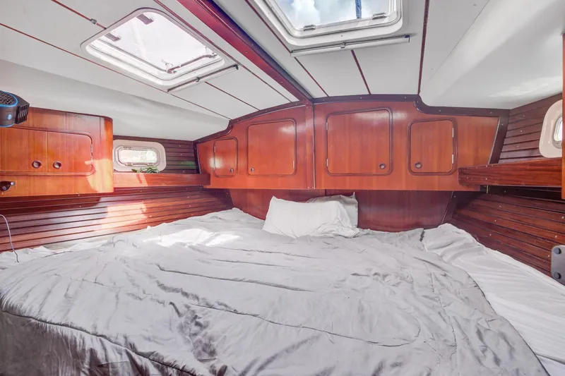 Grace Yacht Photos Pics Luxurious cabin interior of a 1994 Beneteau 510 yacht with wooden paneling.
