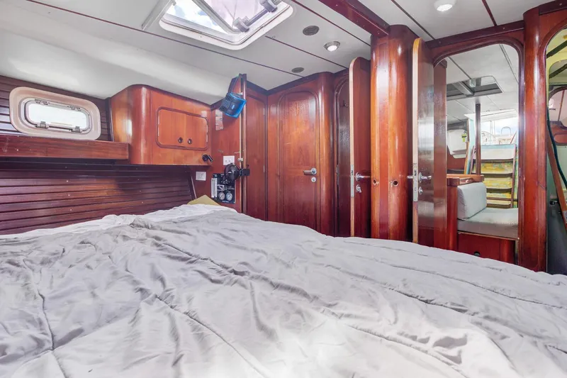 Grace Yacht Photos Pics Cozy cabin interior of 1994 Beneteau 510 sailboat with wooden finishes and comfortable bedding.