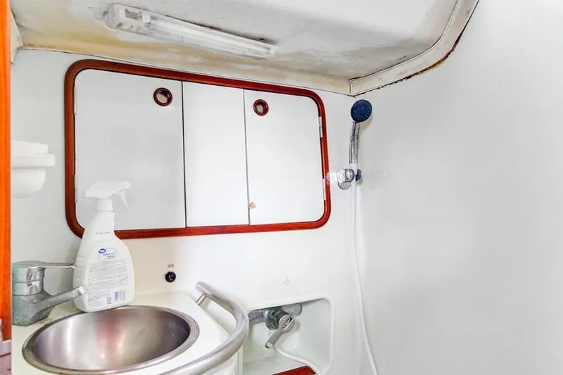 Grace Yacht Photos Pics Bathroom interior of 1994 Beneteau 510 yacht with sink and showerhead.