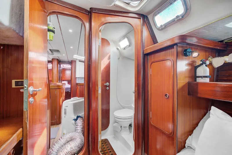 Grace Yacht Photos Pics Interior of 1994 Beneteau 510 yacht featuring wooden cabinetry and compact bathroom.
