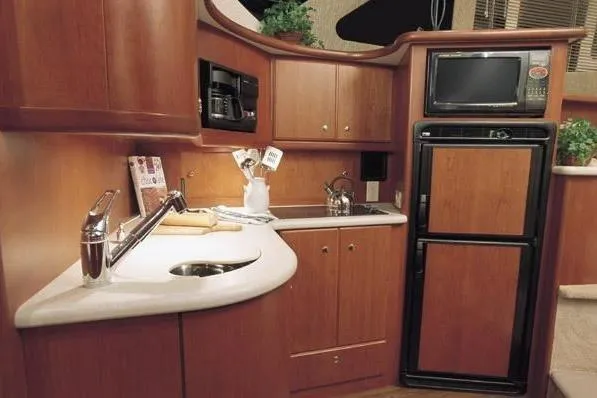 Yacht Photos Pics Luxurious kitchen interior of 2005 Silverton 34 Convertible yacht with wood cabinetry and appliances.