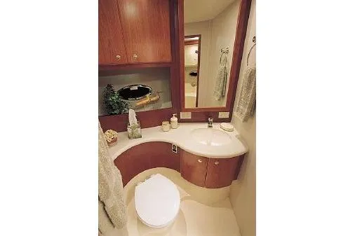  Yacht Photos Pics 2005 Silverton 34 Convertible yacht bathroom with modern fixtures and wooden cabinetry.