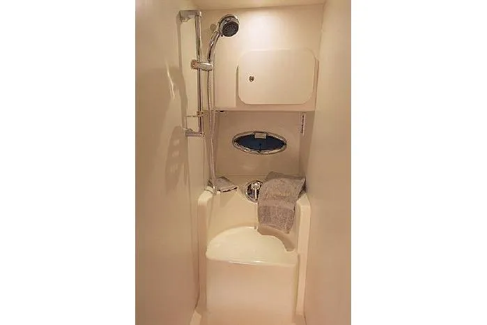  Yacht Photos Pics Shower area in 2005 Silverton 34 Convertible yacht, featuring a compact design with a porthole.