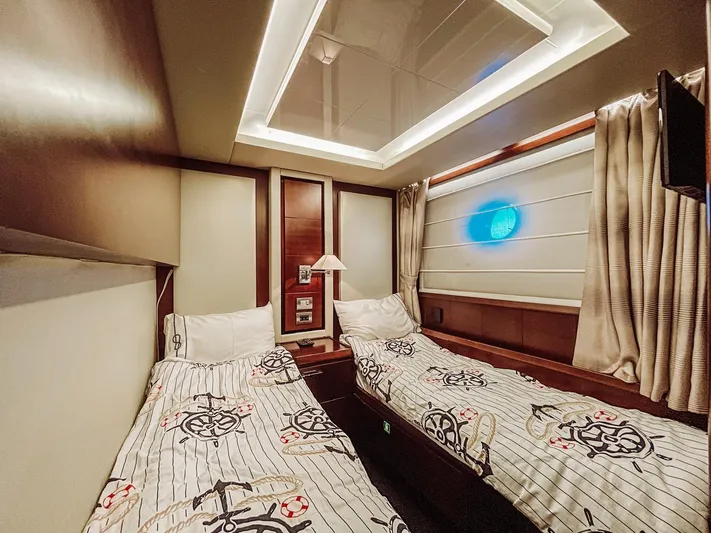  Yacht Photos Pics Luxurious twin cabin interior on a 2009 Azimut 75 yacht, featuring nautical-themed bedding.